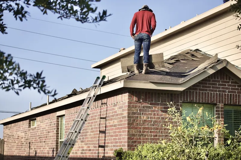 Professional roofer working on a residential roof in French Valley